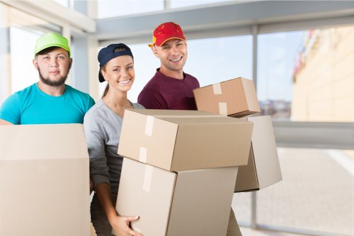 Packed boxes and furniture being loaded into a removals van